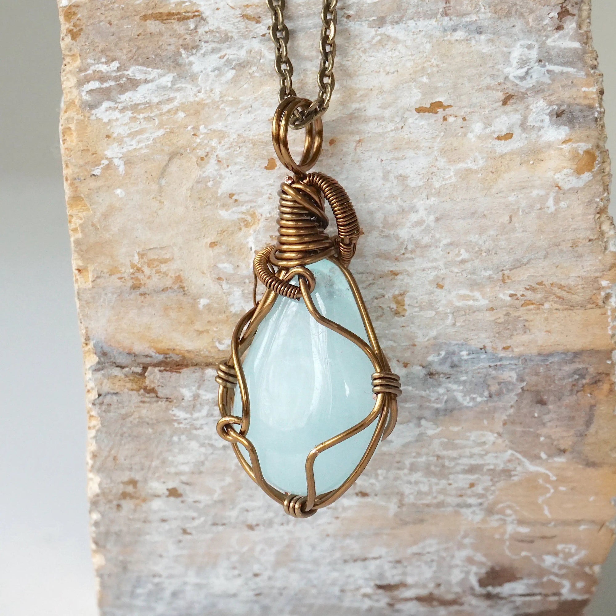Back angle view of genuine aquamarine necklace, handcrafted wire wrapped jewelry by Designs by Nature Gems.