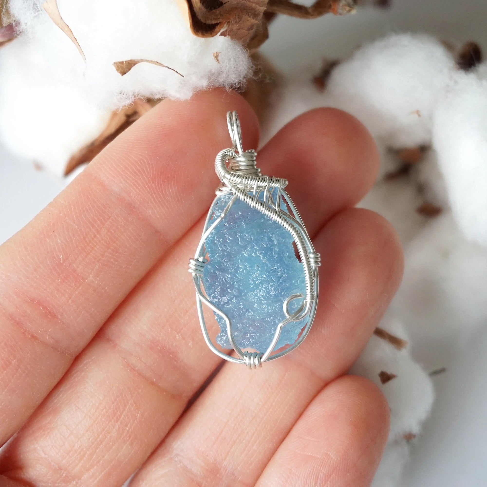 Raw aquamarine necklace in hand for size reference, artisan wire wrapped, 925 sterling silver