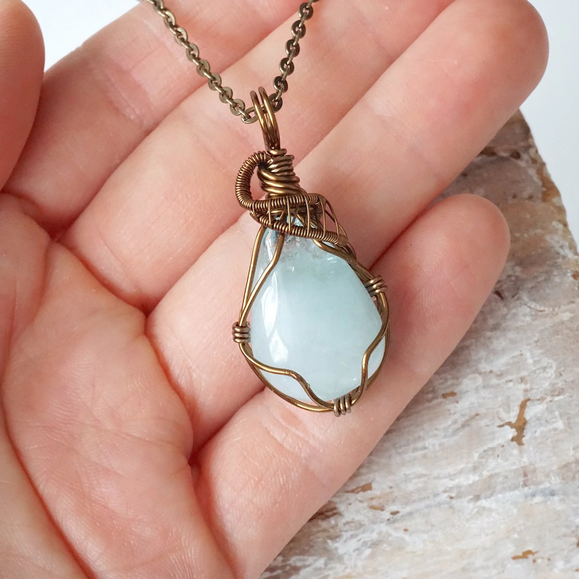 Genuine aquamarine necklace shown in hand for size reference, handcrafted artisan jewelry by Designs by Nature Gems.
