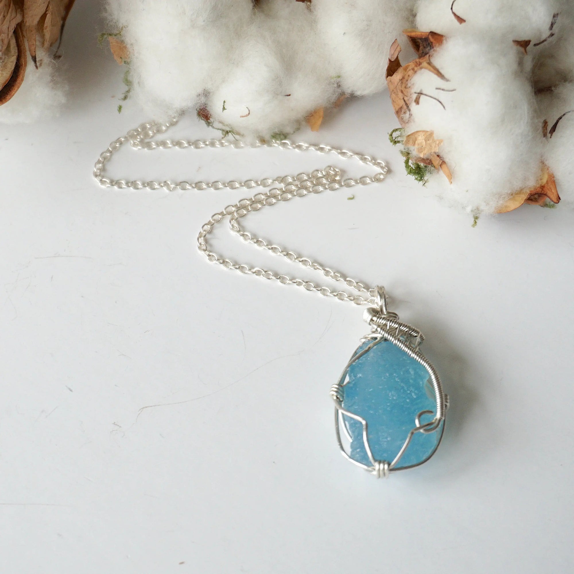 Full look at raw aquamarine necklace laying flat, handcrafted sterling silver, Designs by Nature Gems