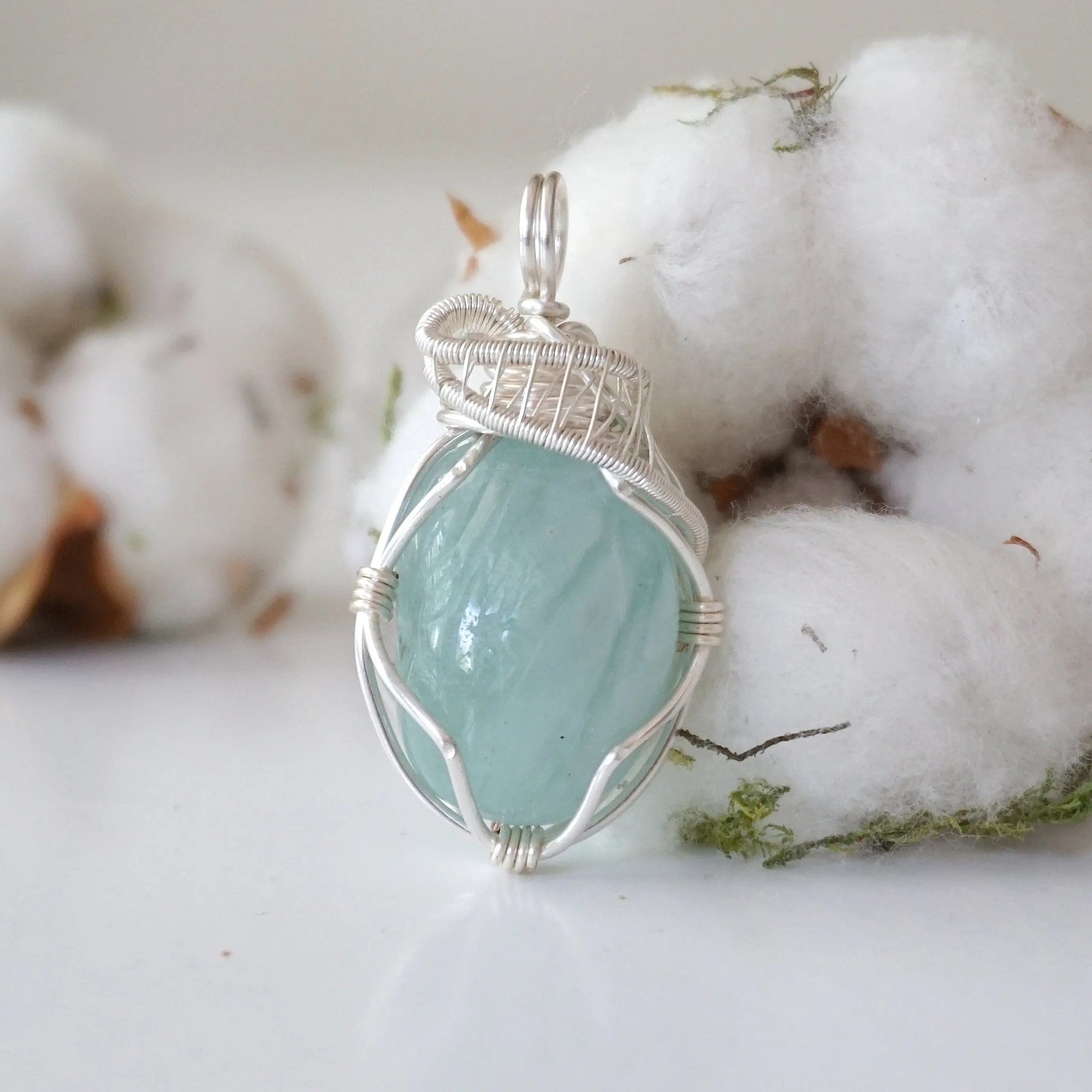 Detailed front angle of aquamarine pendant necklace for women, artisan wire wrapped, soft silver finish