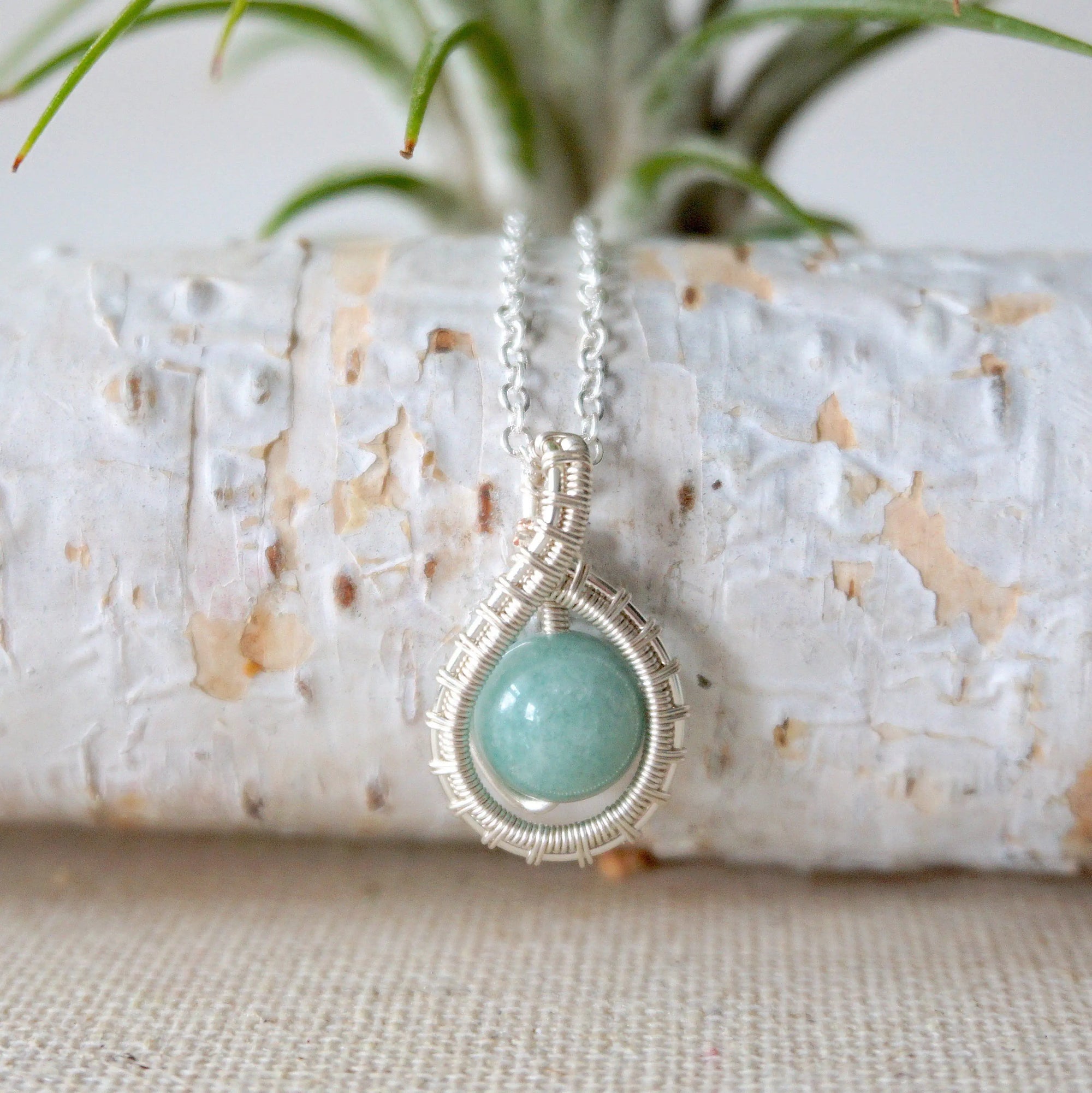 Detailed front view of aquamarine necklace for women, artisan wire wrapped in soft silver finish, Designs by Nature Gems