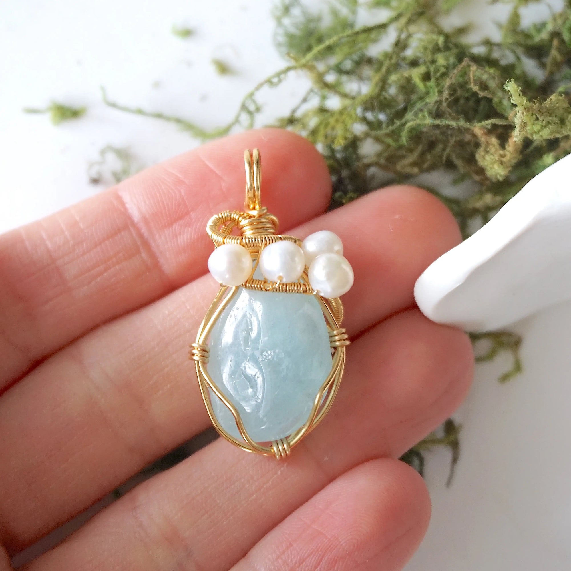 Aquamarine and freshwater pearl necklace pendant in hand for size reference, artisan birthstone jewelry gift for her