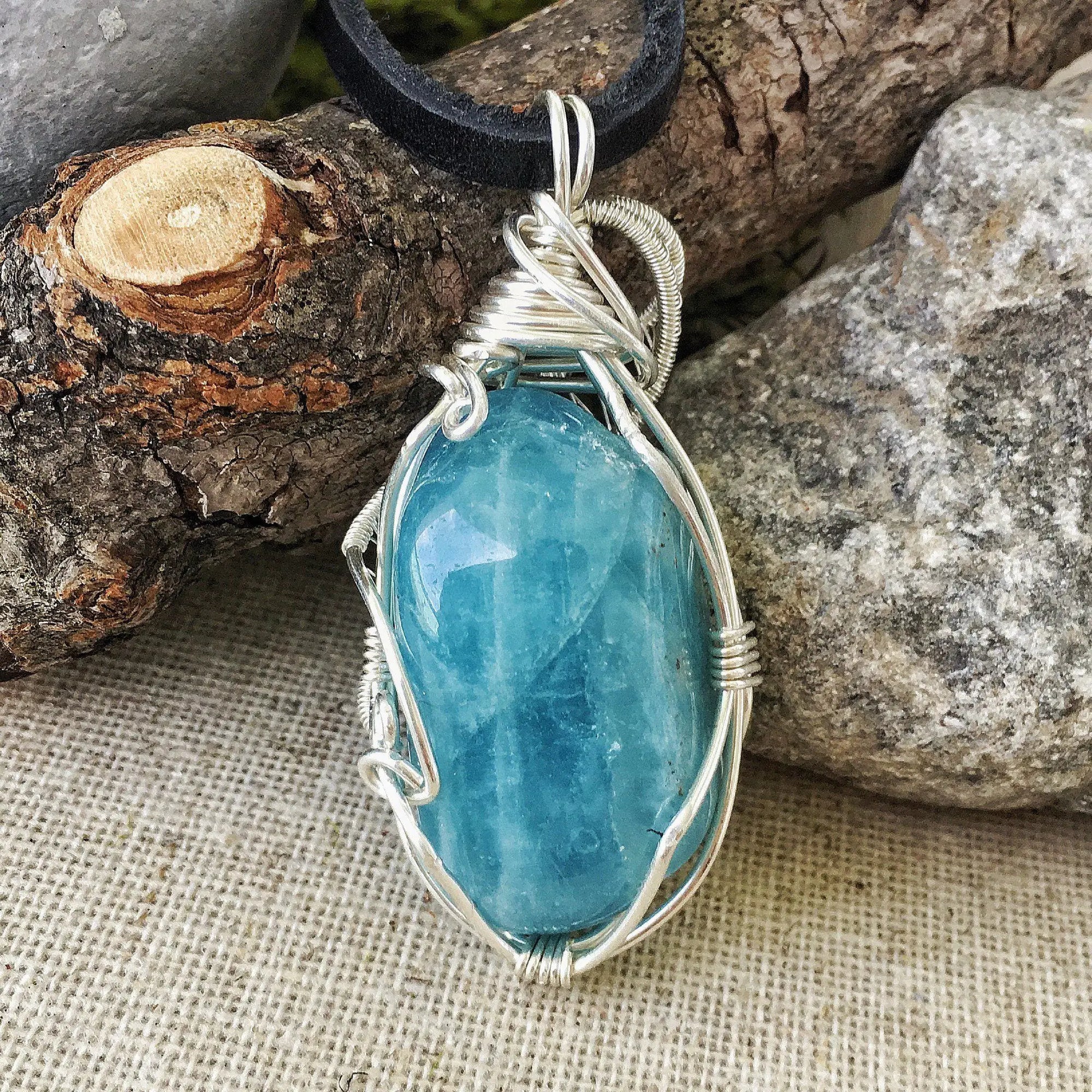 Back view of polished aquamarine pendant, genuine stone with handcrafted sterling silver wire, men's necklace
