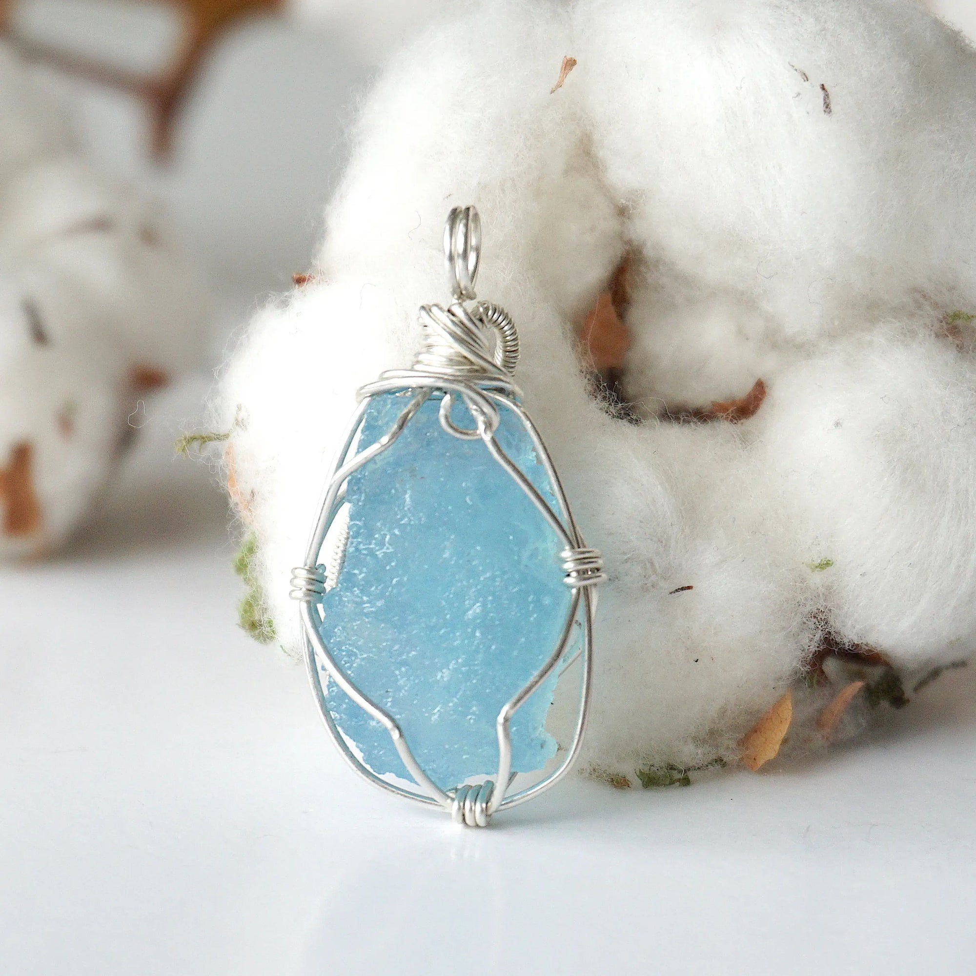Back view of raw aquamarine pendant, genuine stone with handcrafted sterling silver wire
