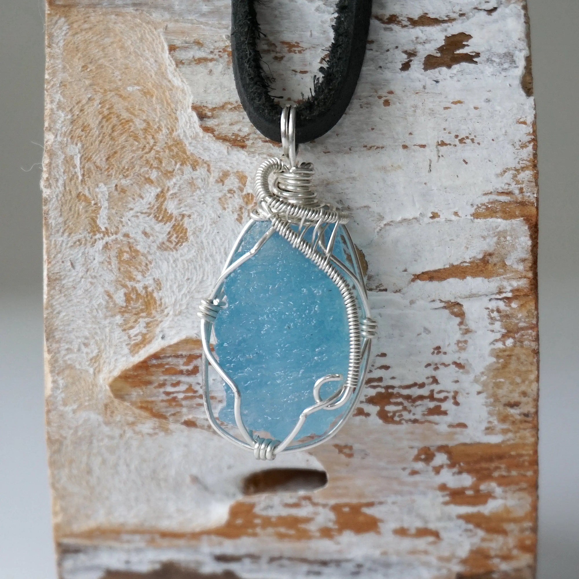 Close-up of raw aquamarine pendant front, artisan wire wrapped in 925 sterling silver, men's necklace