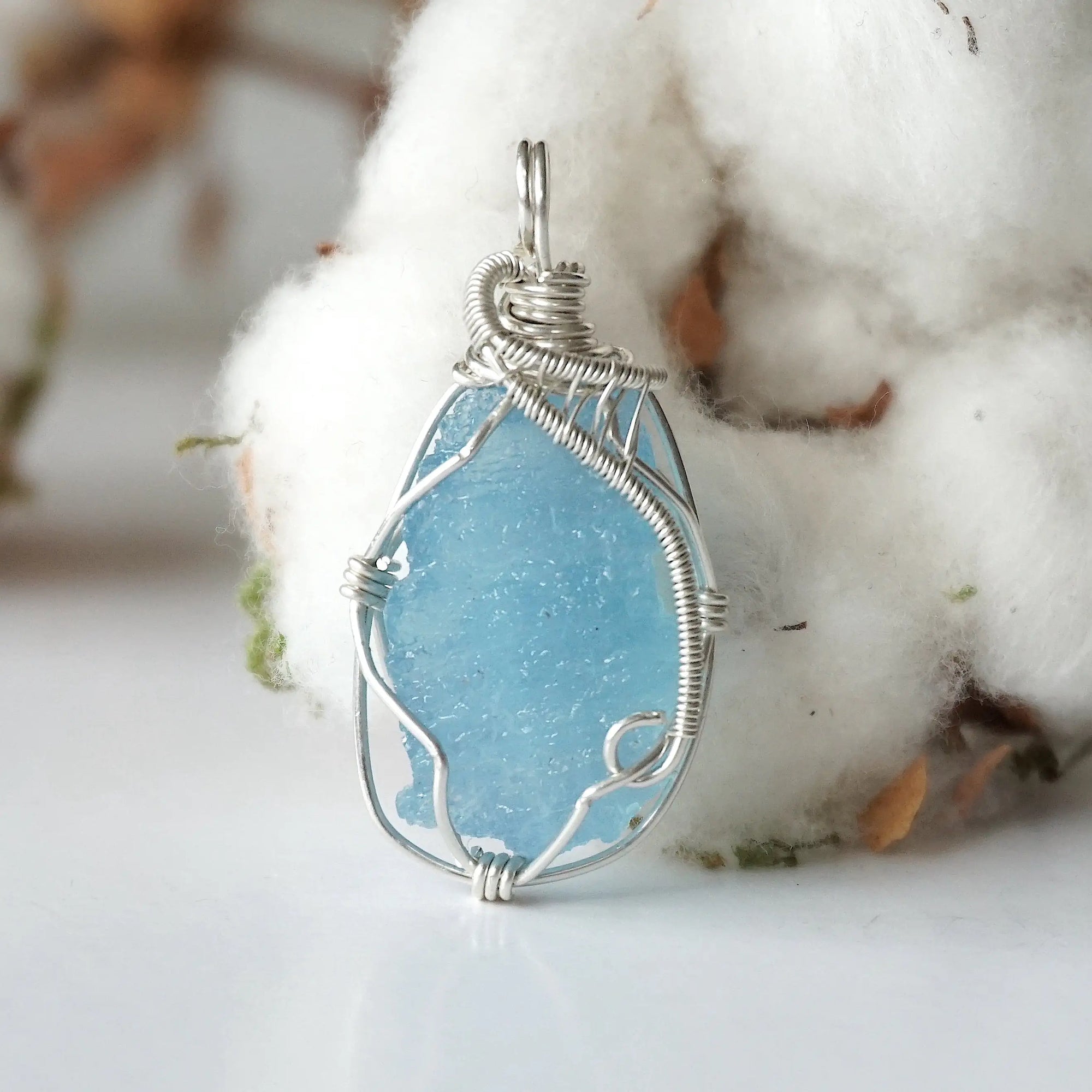 Close-up of raw aquamarine pendant front, artisan wire wrapped in 925 sterling silver