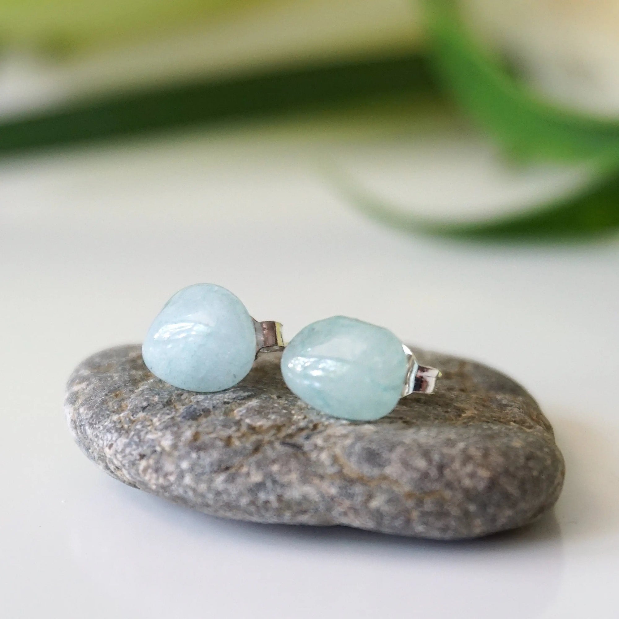 Detailed front view of aquamarine stud earrings, raw natural stones on sterling silver posts, gender neutral, Designs by Nature Gems
