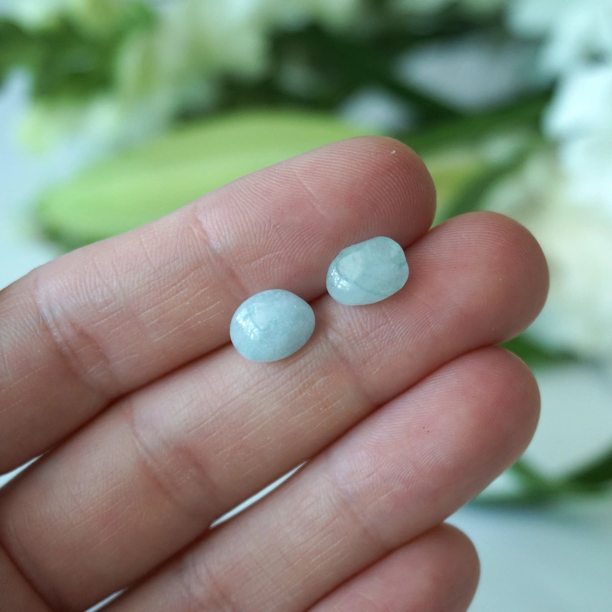 Aquamarine stud earrings in hand for size reference, genuine raw stones, sterling silver posts