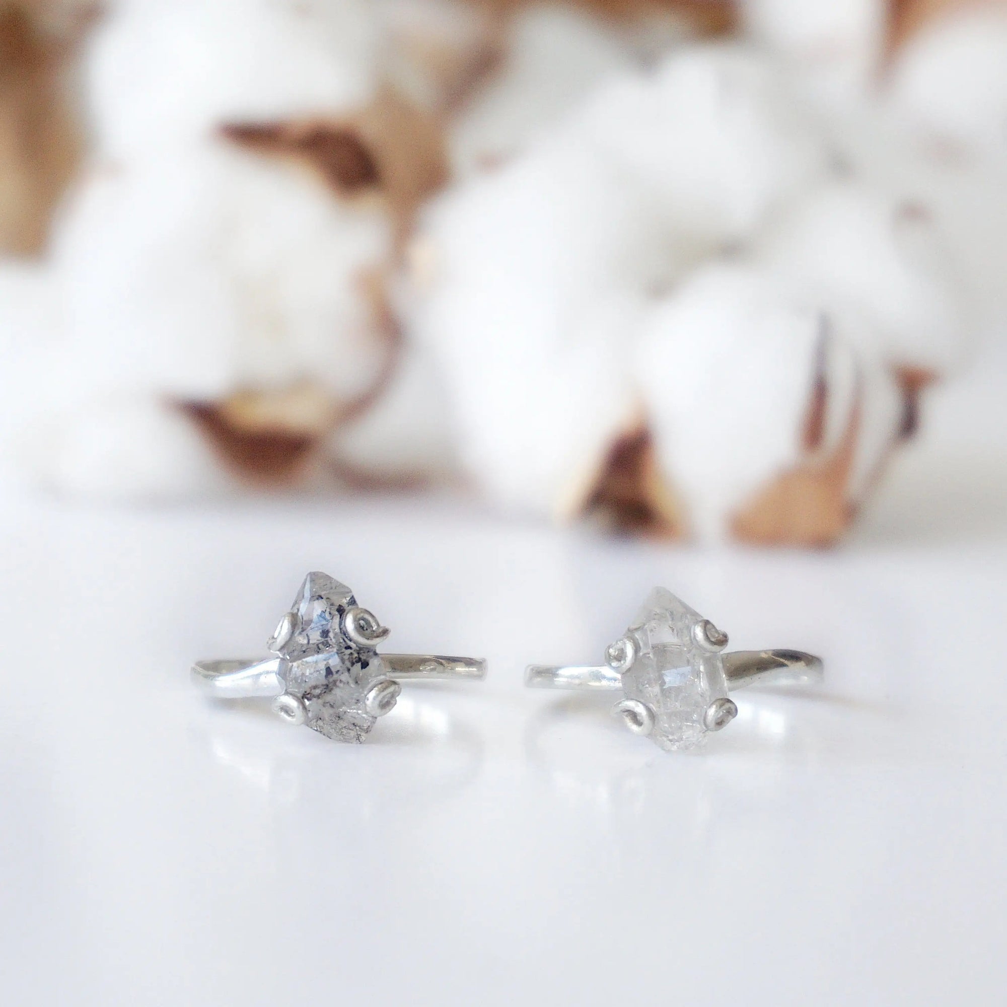 Two adjustable raw Herkimer diamond rings in 925 sterling silver showing natural variation in stone size and shape.