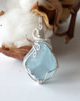 Front view of a natural blue topaz necklace pendant wrapped in 925 sterling silver