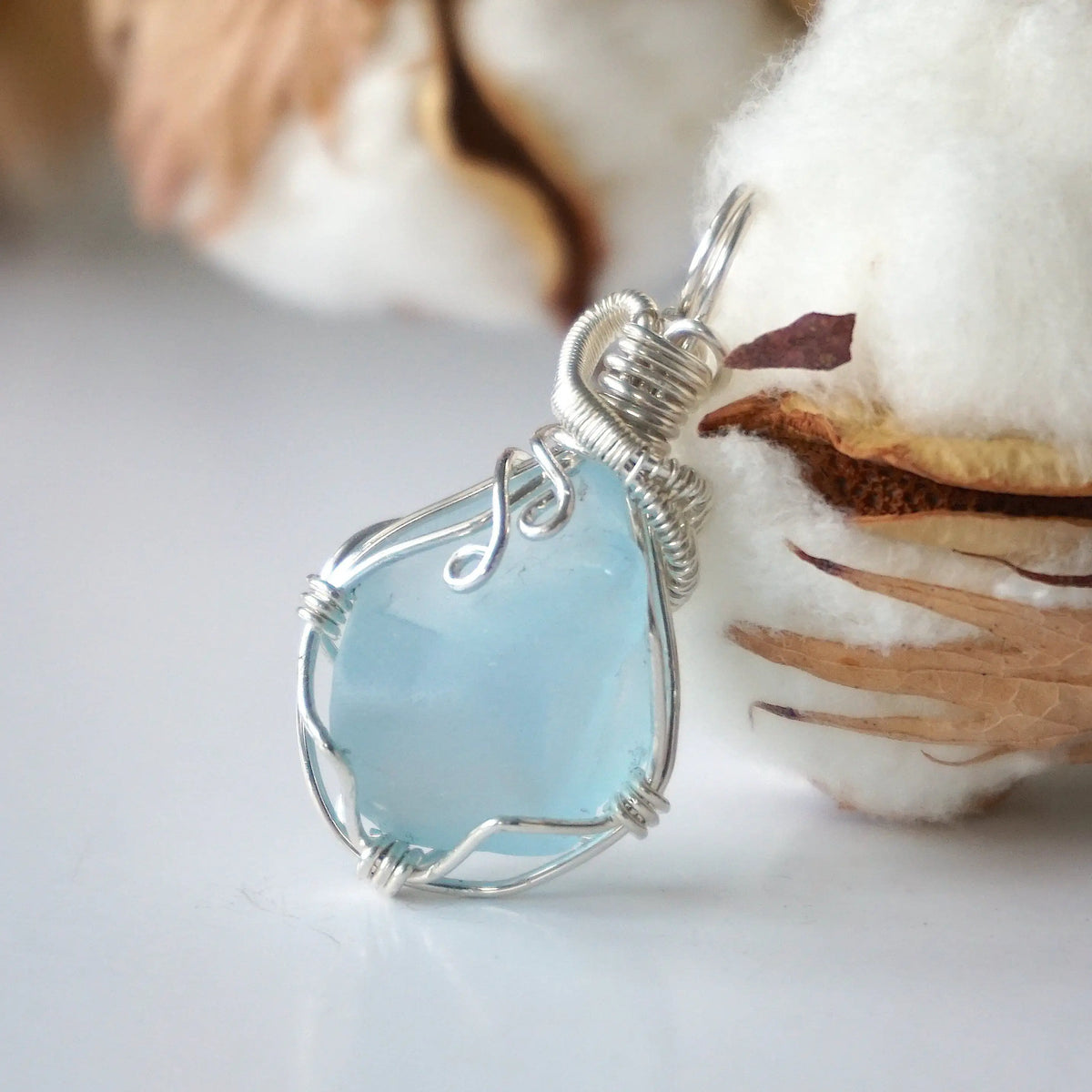 Natural blue topaz framed by a handmade 925 sterling silver wire wrap
