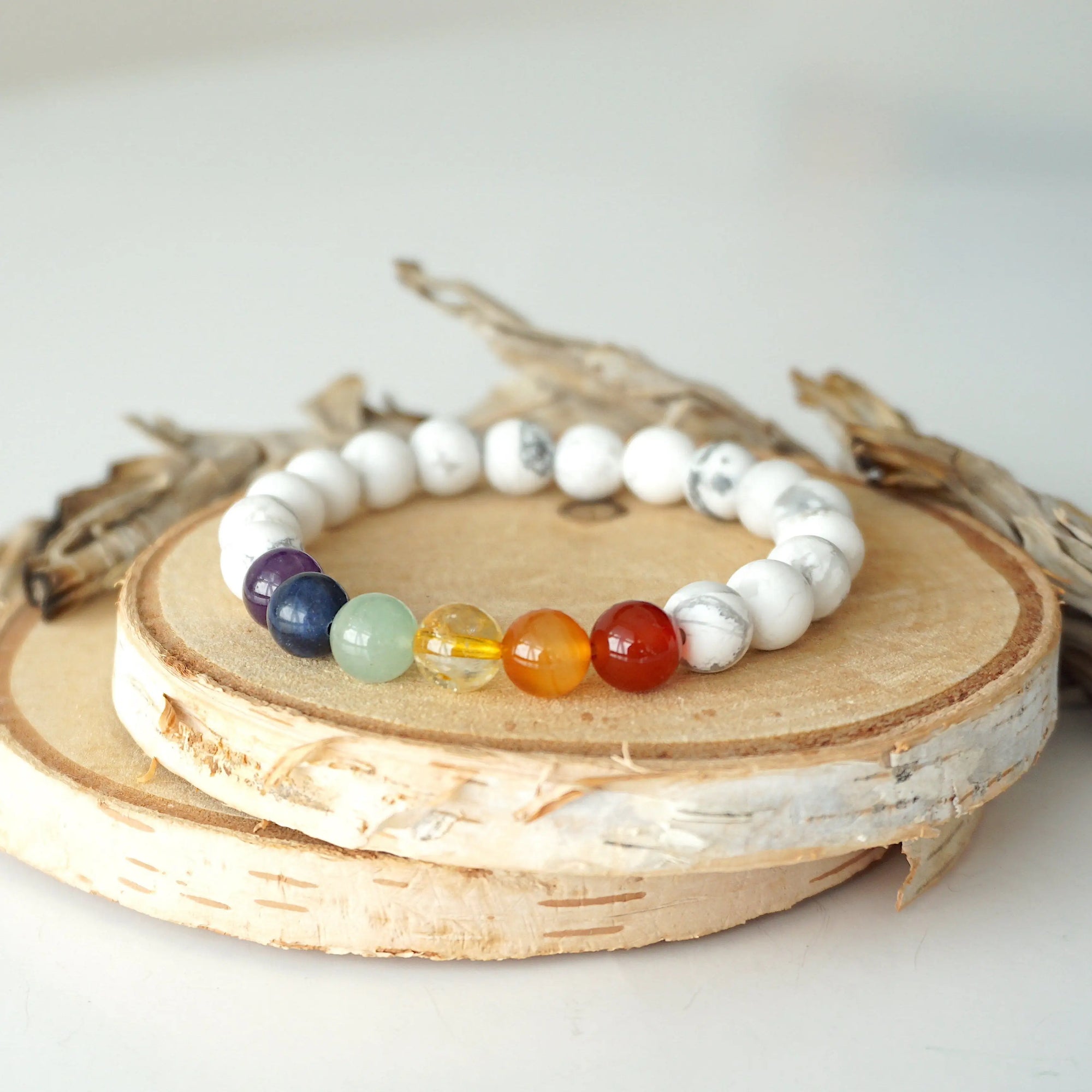 Detailed view of chakra beaded stretch bracelet, natural white howlite and 7 chakra gemstone beads, unisex design