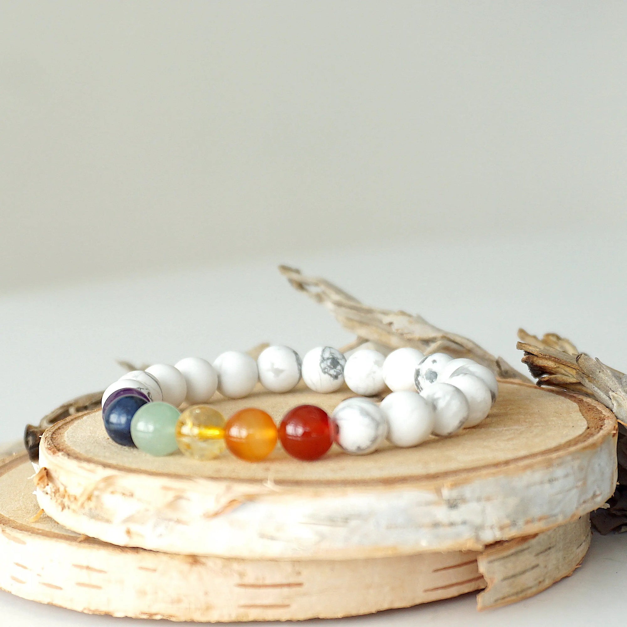 Left side view of chakra beaded stretch bracelet, natural white howlite and 7 chakra gemstone beads