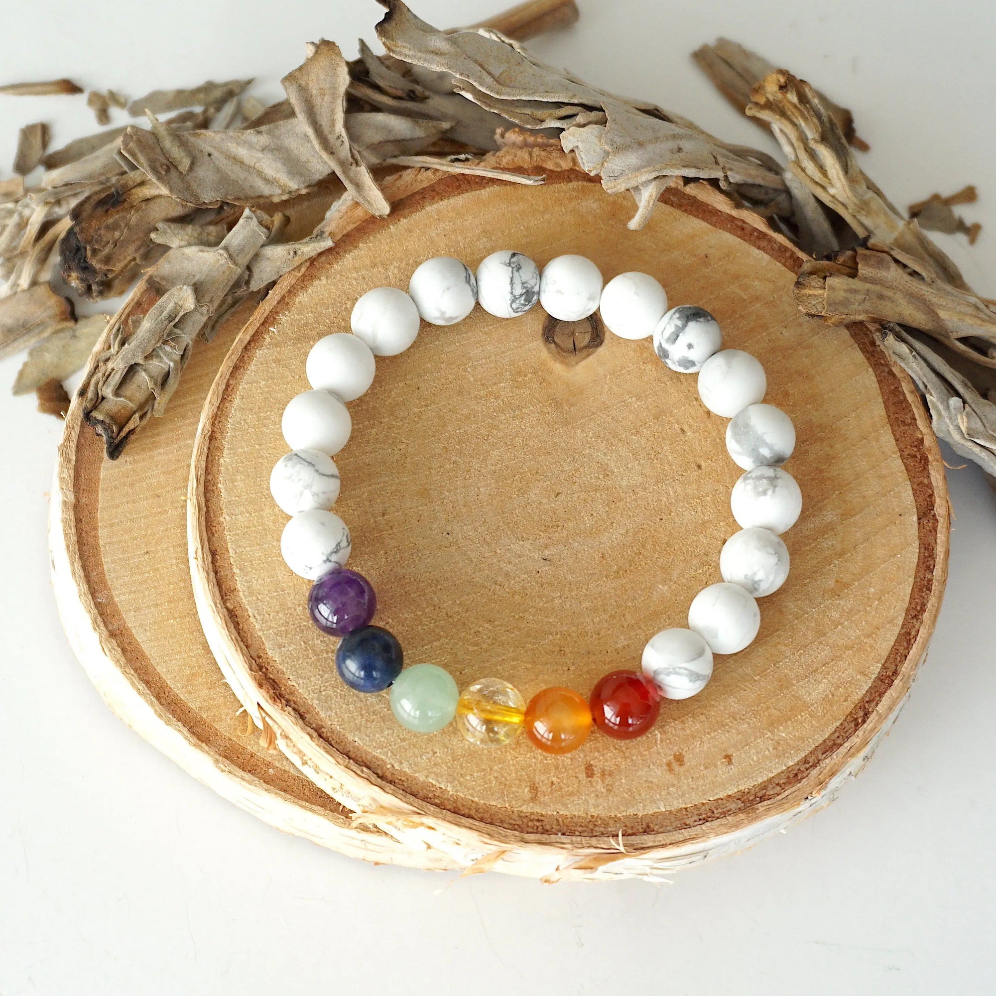 Top view of chakra beaded stretch bracelet, natural white howlite and 7 chakra gemstone beads, unisex design