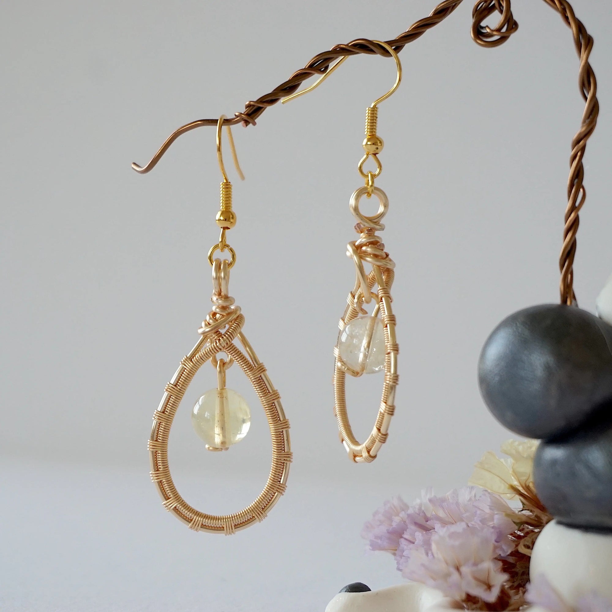 Close up wire detail of natural citrine crystal earrings- handmade drop earrings showing artisan craftsmanship and golden stone