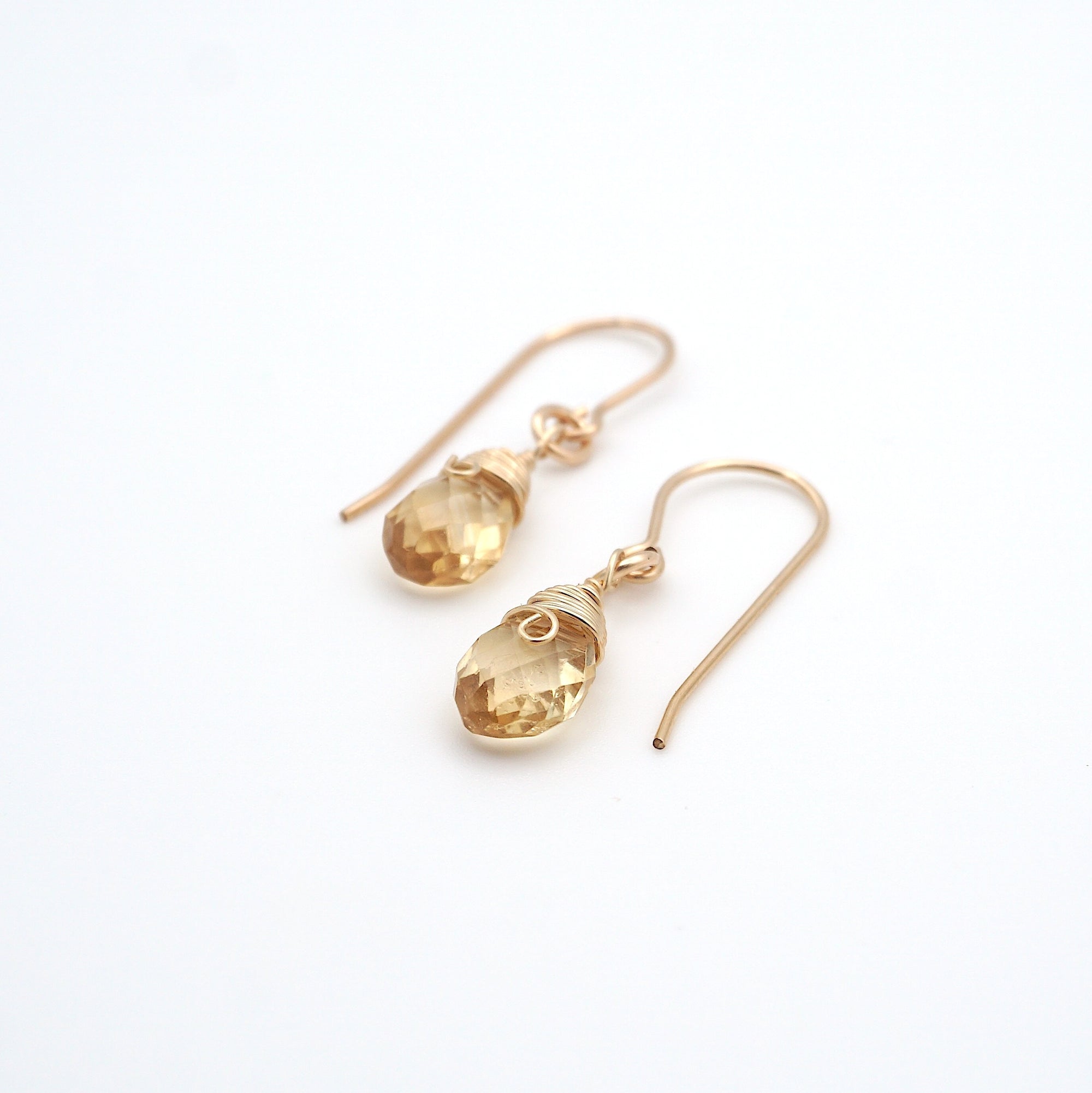 Angled look at citrine drop earrings, artisan wire wrapping in 14k gold filled, November birthstone