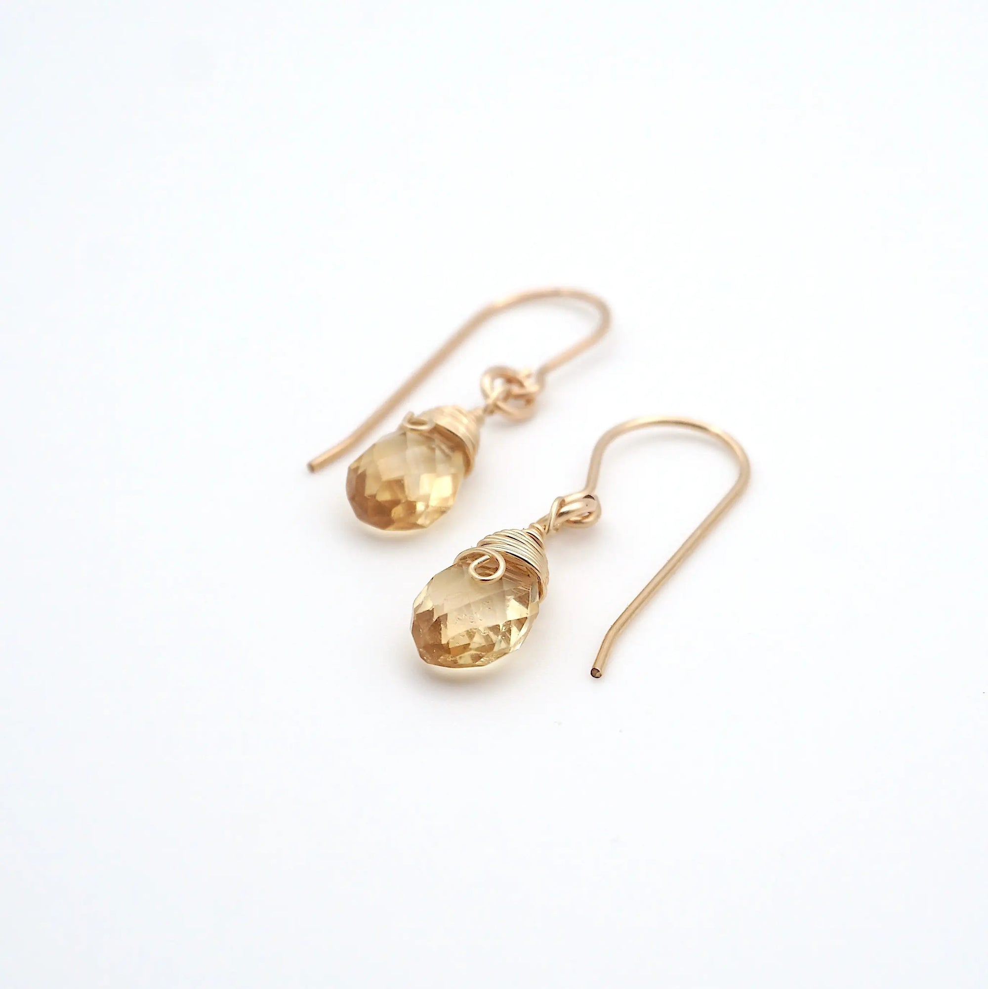 Angled look at citrine drop earrings, artisan wire wrapping in 14k gold filled, November birthstone