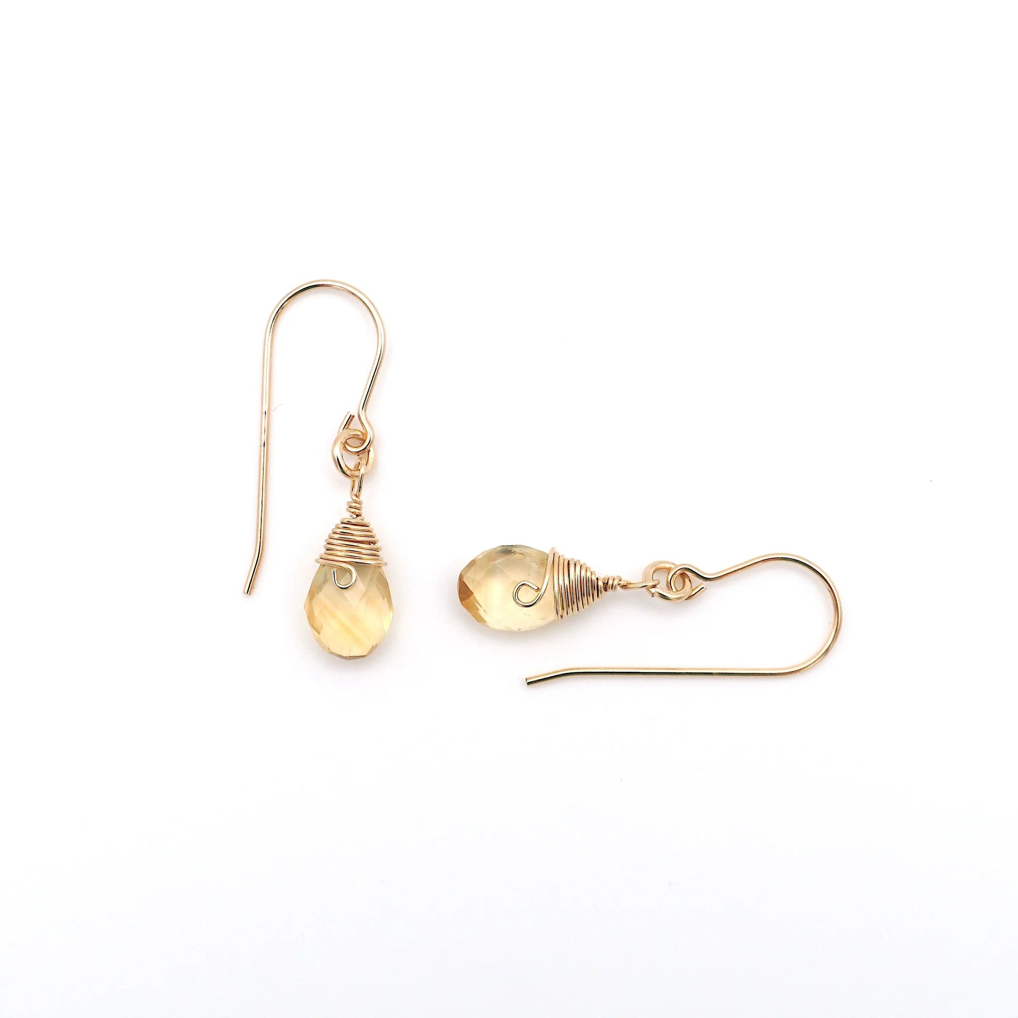 Closeup showing details of citrine drop earrings, faceted citrine stone, 14k gold filled setting