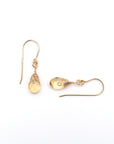 Closeup showing details of citrine drop earrings, faceted citrine stone, 14k gold filled setting