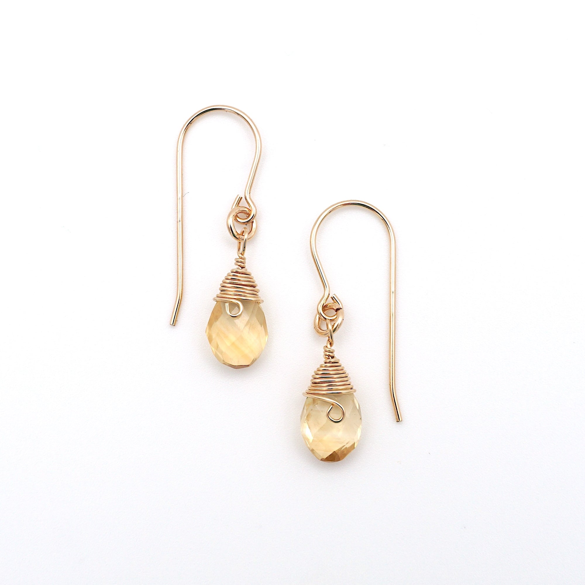 Detailed front view of citrine drop earrings, genuine faceted citrine with minimalist 14k gold filled wire wrapping, Designs by Nature Gems