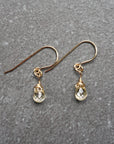 Close up detail of natural citrine crystal wire wrapped in 14k gold filled metal - handmade drop earrings showing artisan craftsmanship and golden stone
