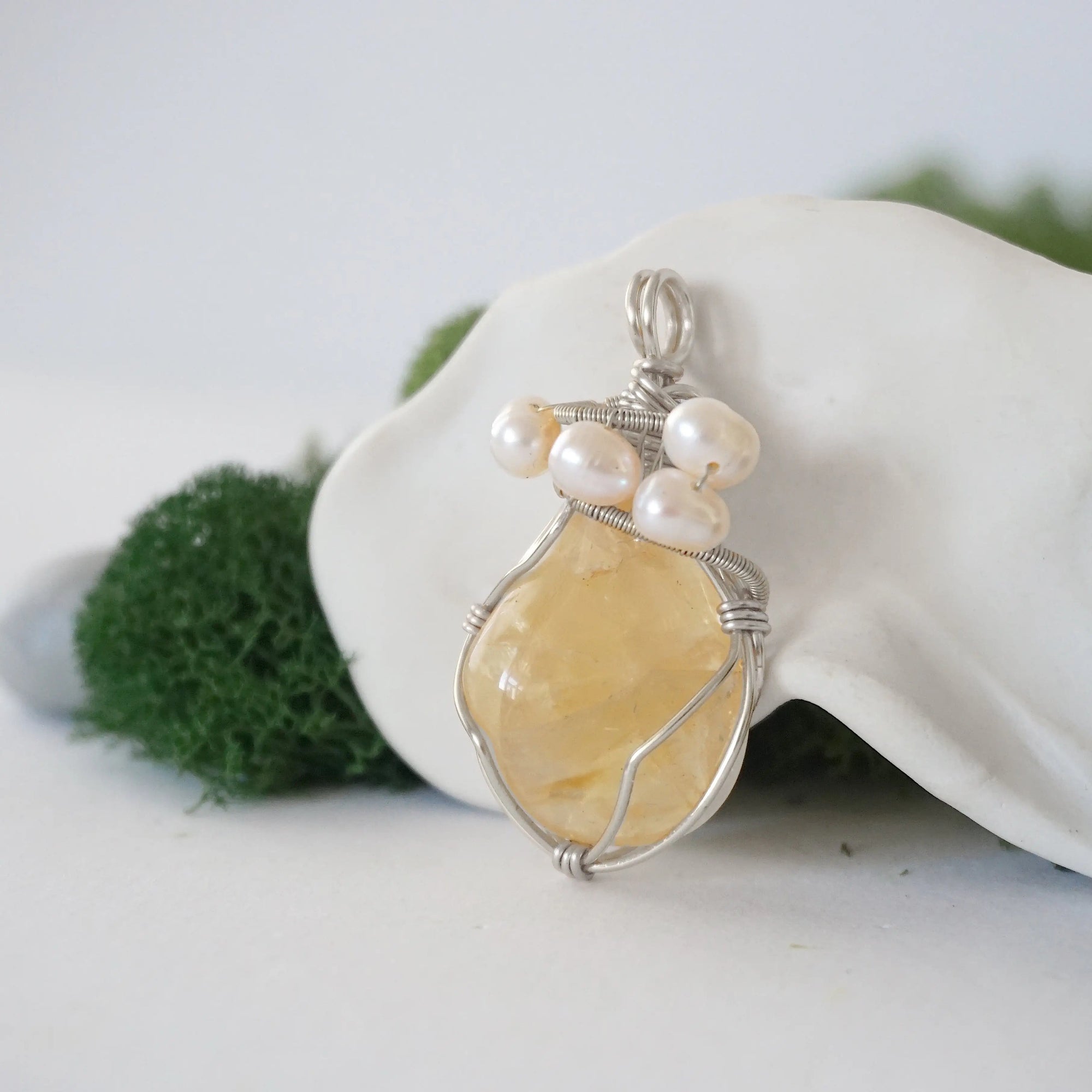 Side angle of handmade citrine and freshwater pearl pendant necklace, silver wire wrapped jewelry