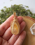 Citrine pendant gold wire wrapped held in hand showing size November birthstone necklace gift for women
