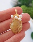 Citrine and pearl necklace size comparison in hand showing pendant dimensions - natural crystal freshwater pearl gold plated handmade jewelry size reference