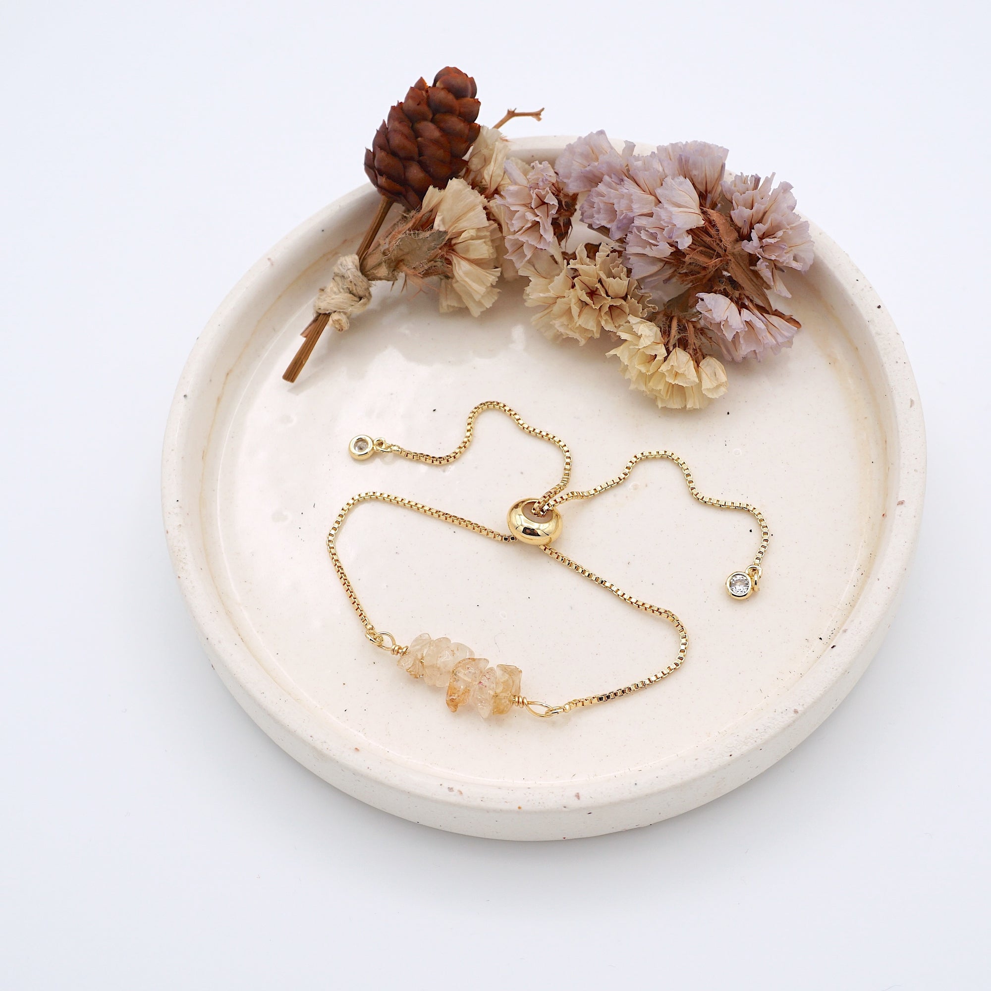 Handmade citrine bracelet displayed on ceramic tray showing natural golden crystals and gold chain - November birthstone gift for her