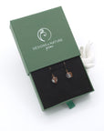 Clear quartz drop earrings presented in a branded gift box, ready for gifting, with antique bronze copper wire wrapping.