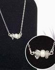 Close-up of raw clear quartz stones and freshwater pearl bar on 925 sterling silver necklace