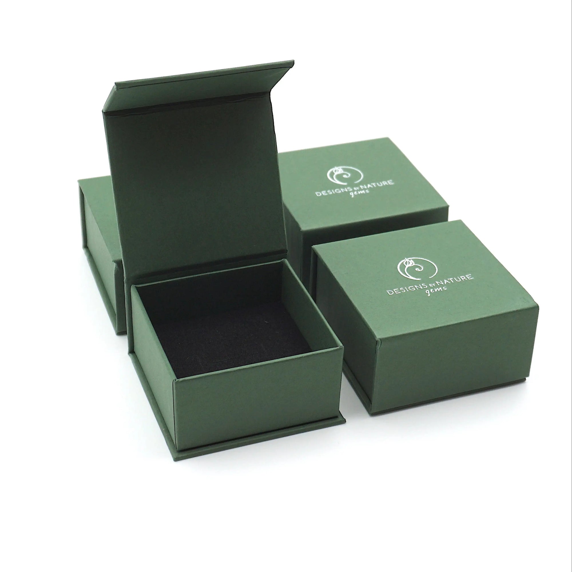 Designs by Nature Gems branded ring box used for packaging a minimalist pearl ring, shown without the ring inside