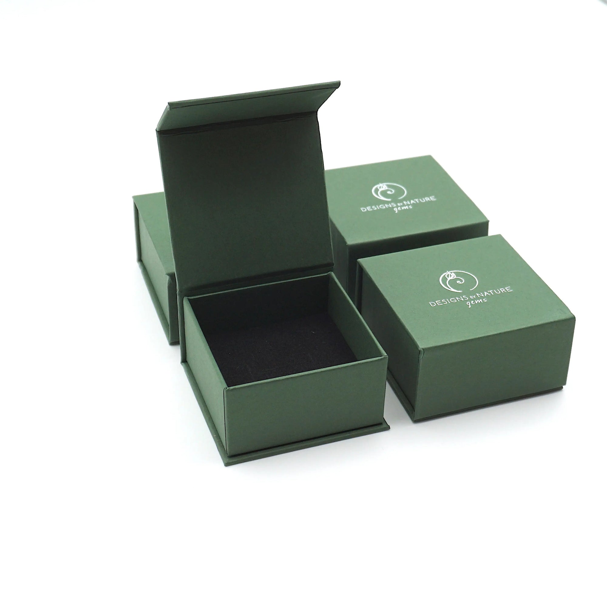 Designs by Nature Gems branded ring box used for packaging wire wrapped garnet rings, shown without the ring inside