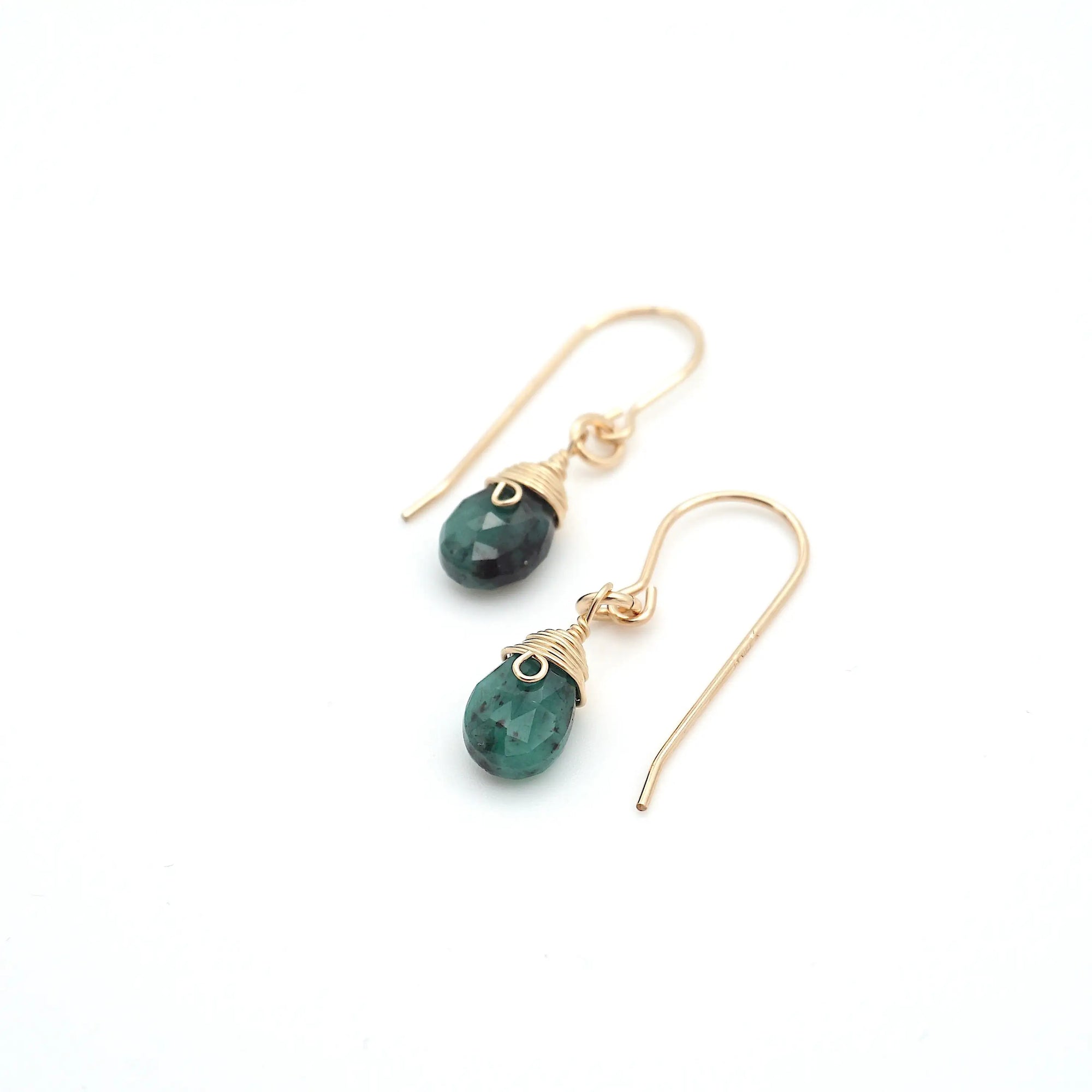 Angled look at emerald drop earrings, artisan wire wrapping in 14k gold filled, May birthstone
