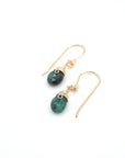 Angled look at emerald drop earrings, artisan wire wrapping in 14k gold filled, May birthstone
