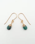 Side angle of emerald drop earrings, minimalist artisan wire wrapping, 14k gold filled
