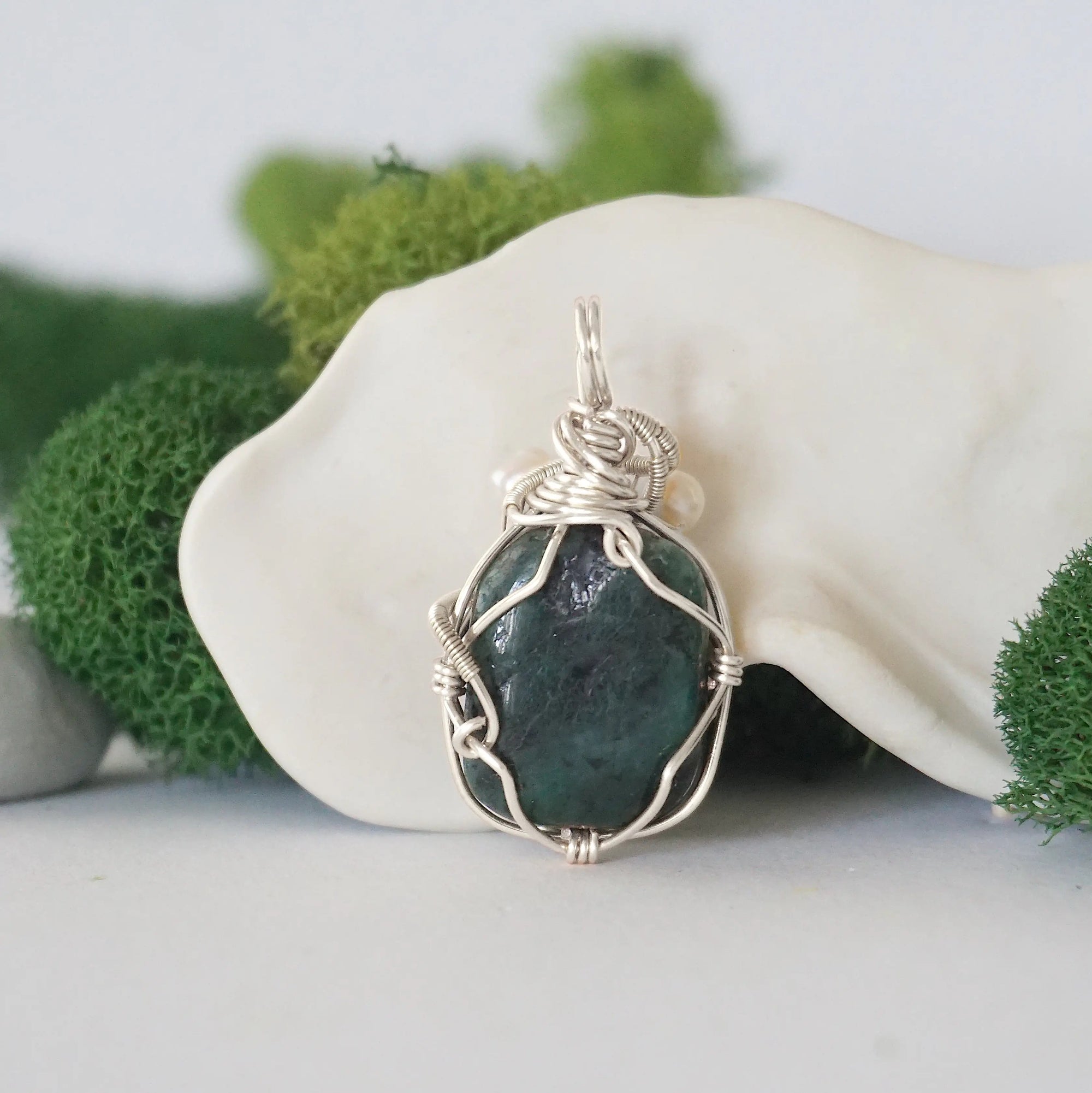 Back detail of silver wire wrapped emerald and freshwater pearl pendant necklace, handcrafted gemstone jewelry