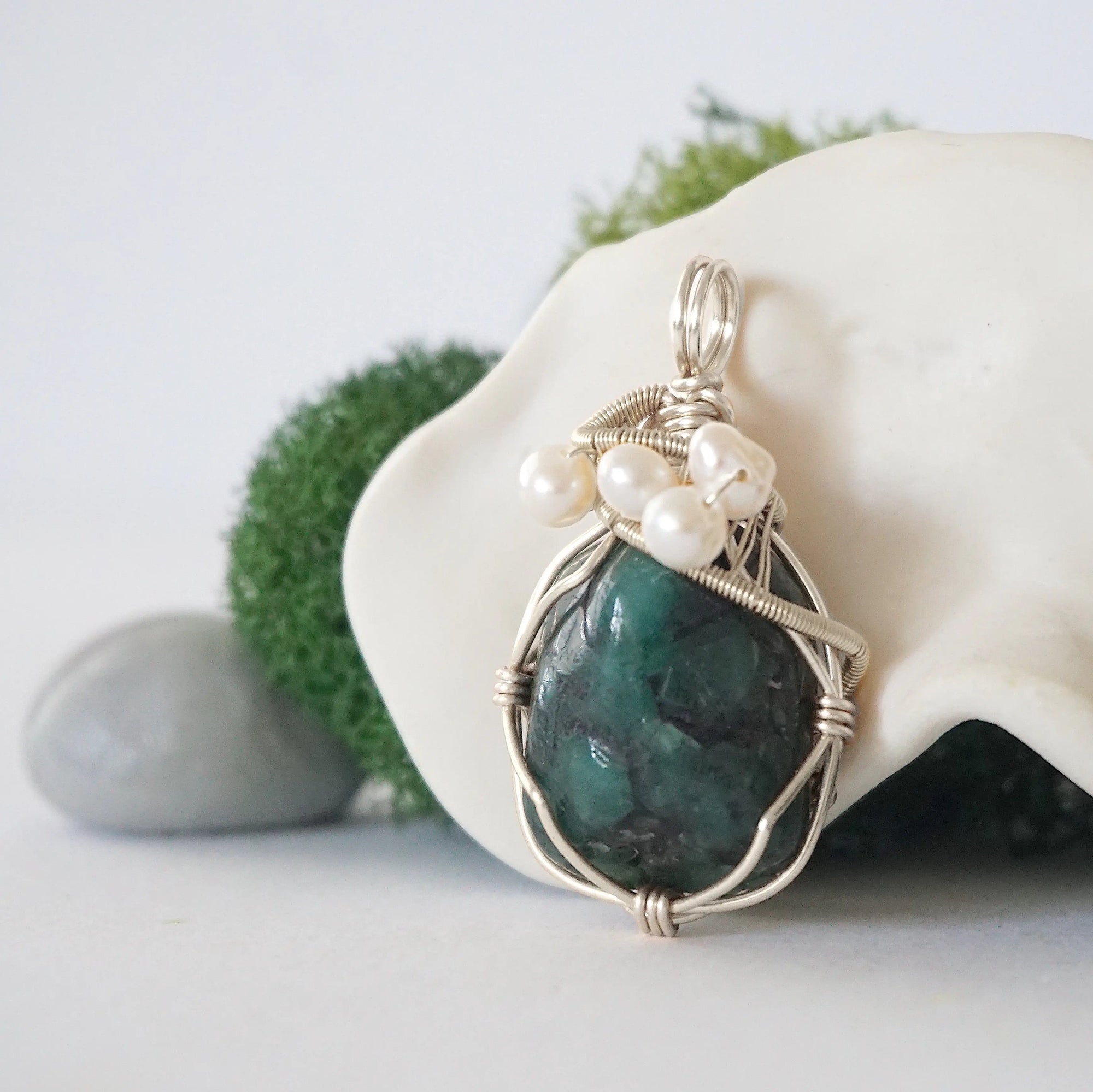 Side angle of handmade emerald and freshwater pearl pendant necklace, silver wire wrapped jewelry