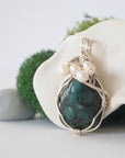 Side angle of handmade emerald and freshwater pearl pendant necklace, silver wire wrapped jewelry