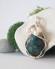 Side angle of handmade emerald and freshwater pearl pendant necklace, silver wire wrapped jewelry