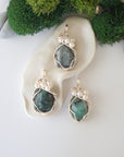 Three silver wire wrapped emerald and freshwater pearl pendants showing natural stone variation, artisan jewelry for women