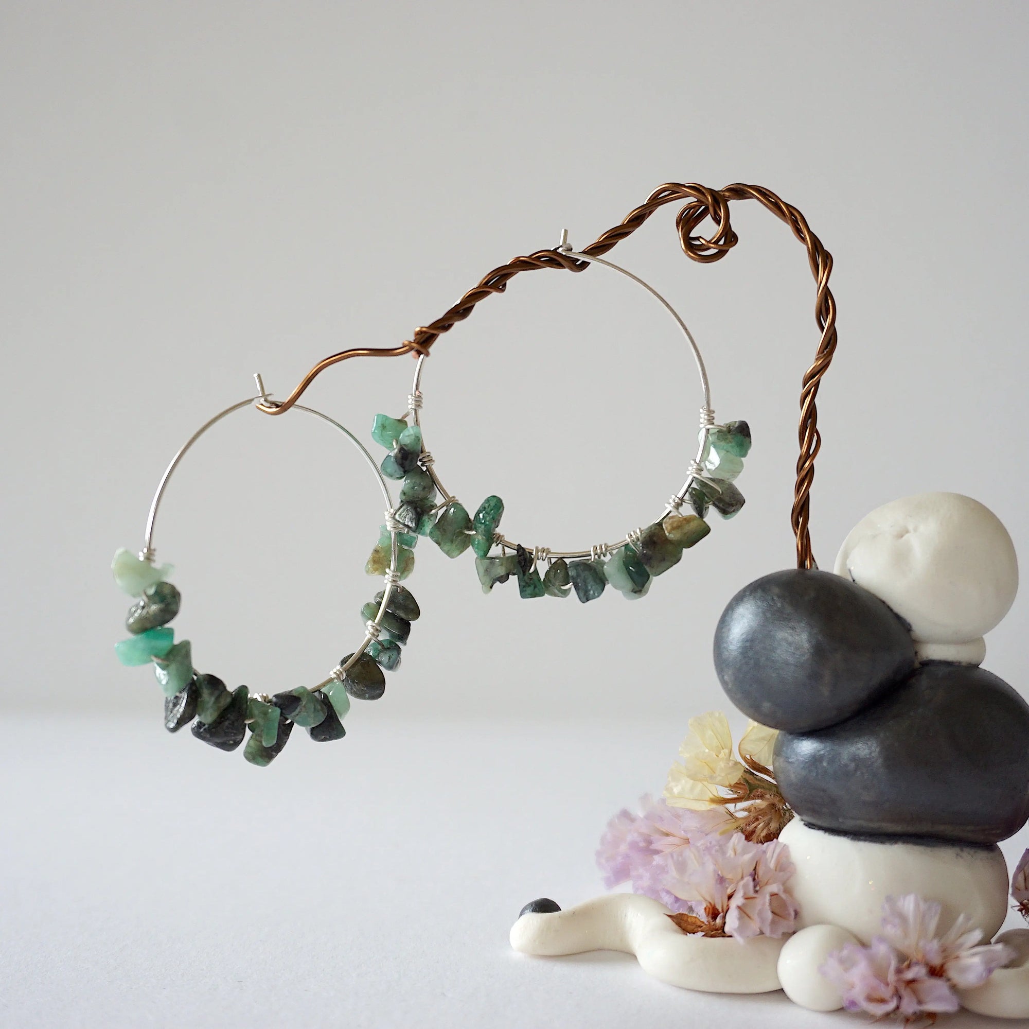 Wire wrapped emerald hoop earrings in soft silver copper with natural emerald chips, detailed artisan jewelry view