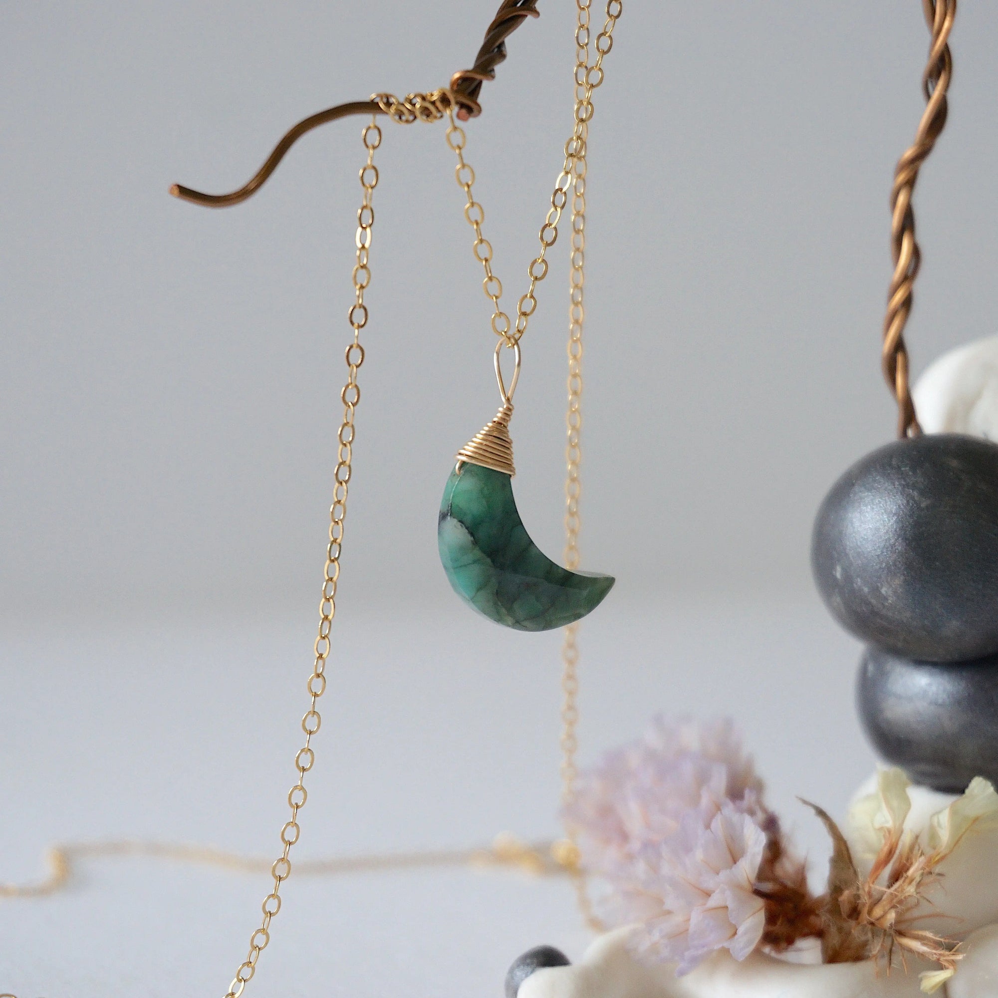 Right angle detail of emerald moon necklace for women with natural faceted emerald and handcrafted 14k gold filled wire wrapping