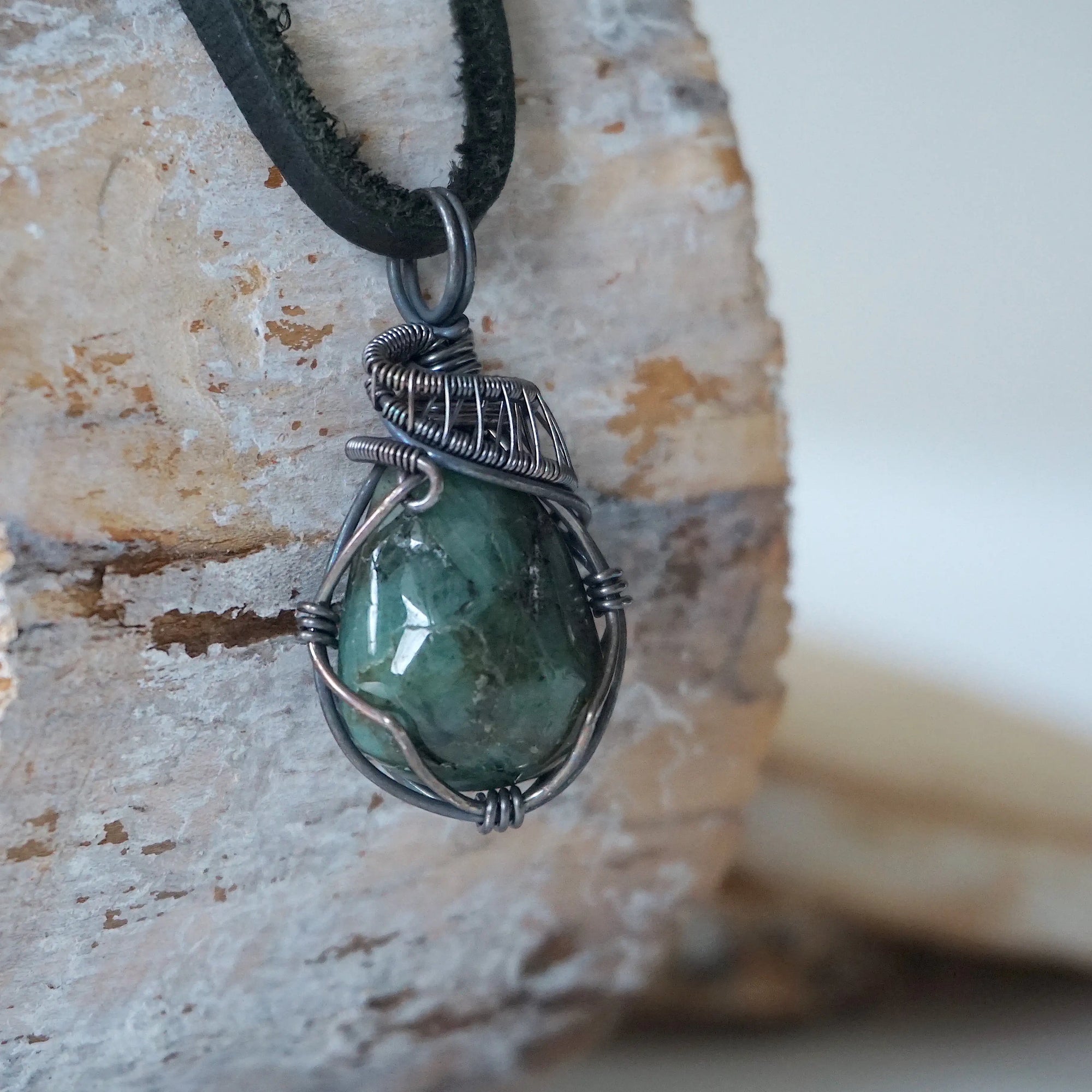 Right angle detail of emerald necklace for men with natural polished-raw emerald and handcrafted antiqued sterling silver wrapping
