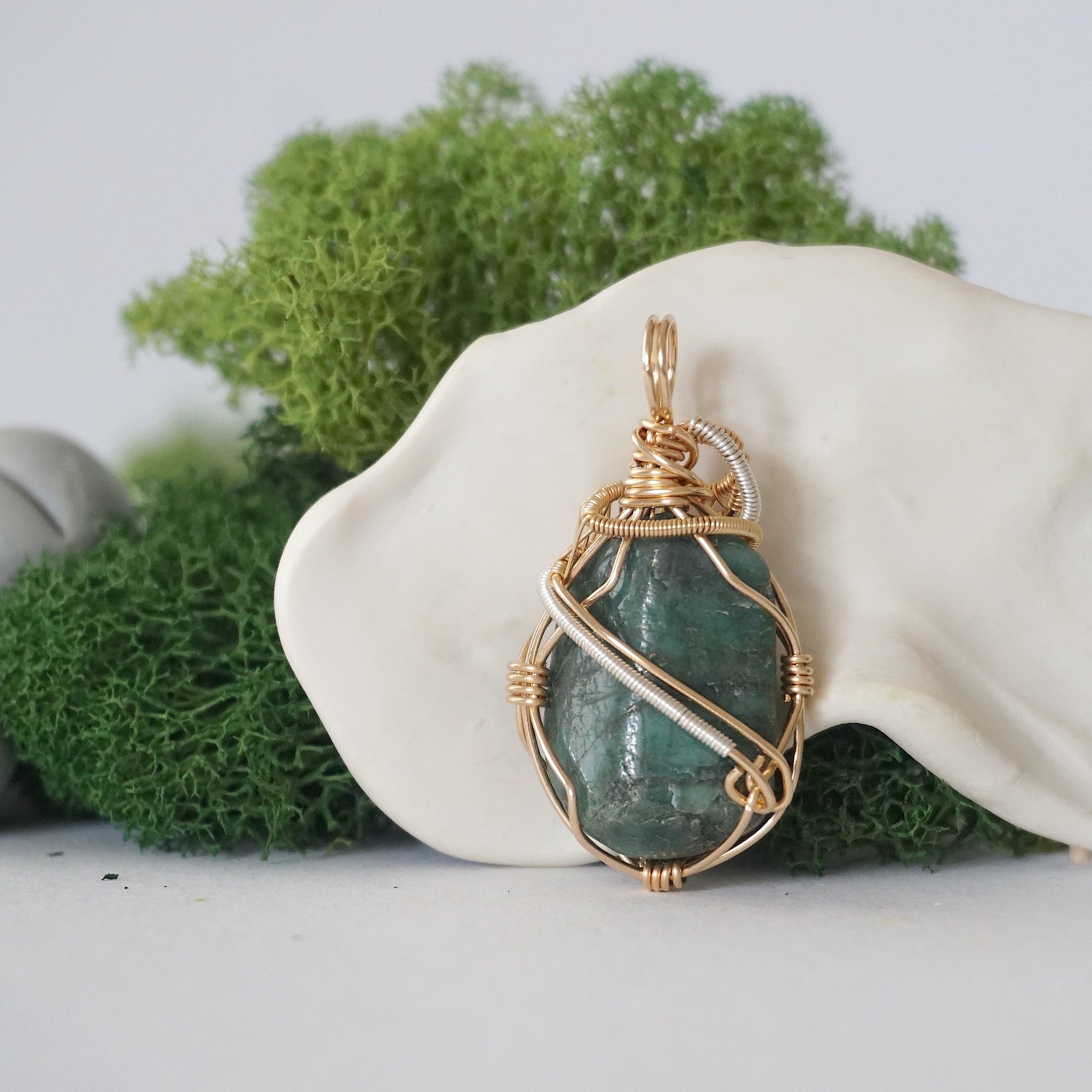 Back angle detail of emerald pendant necklace for women with natural polished-raw emerald and handcrafted gold filled and sterling silver wrapping