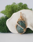 Back angle detail of emerald pendant necklace for women with natural polished-raw emerald and handcrafted gold filled and sterling silver wrapping