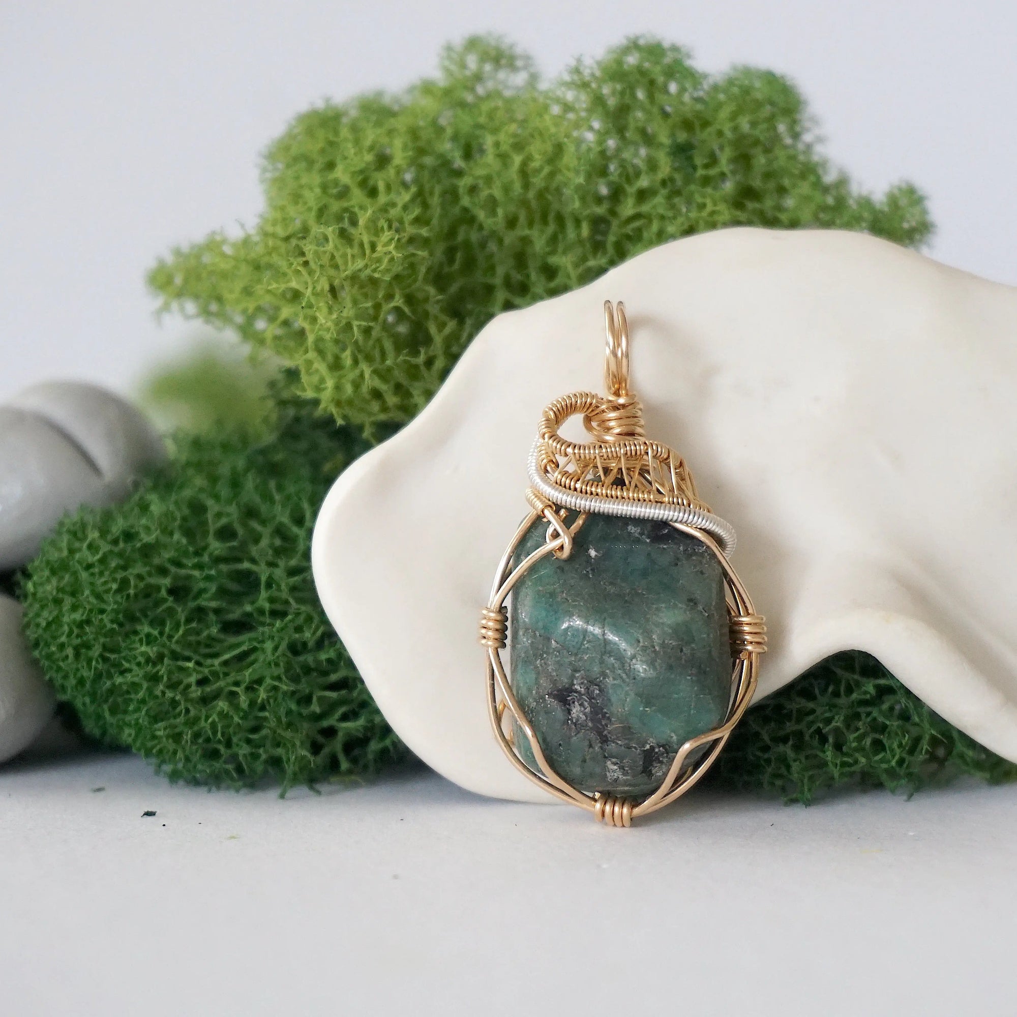 Detailed front view of emerald necklace for women with natural polished-raw emerald and handcrafted 14k gold filled and sterling silver wire wrapping
