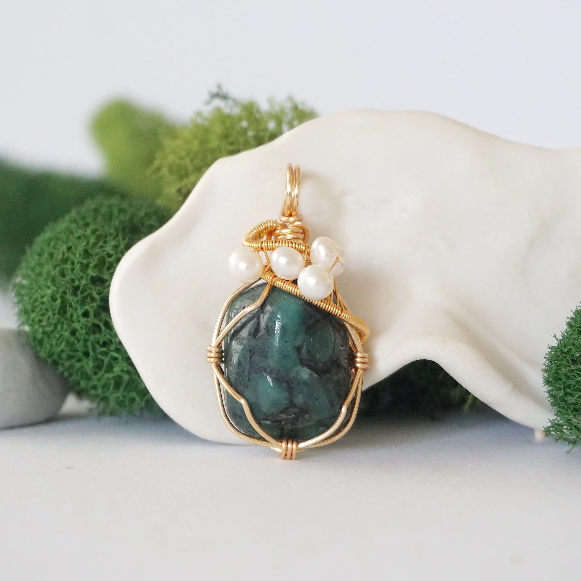 Detailed front angle of emerald and freshwater pearl pendant, gold wire wrapped, handcrafted gemstone jewelry