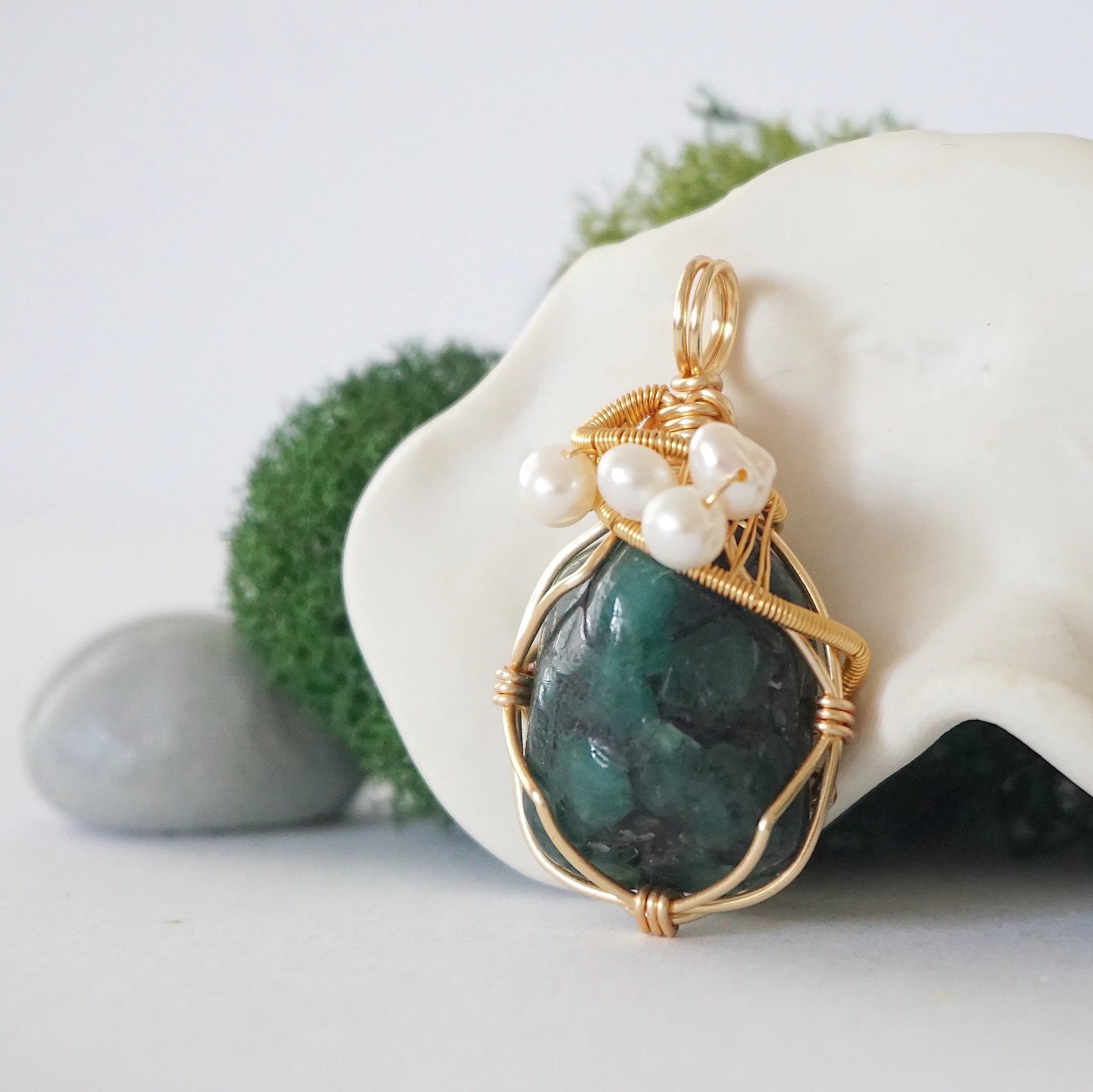 Side angle detail of emerald and freshwater pearl pendant, gold wire wrapped, ethical artisan necklace